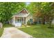Inviting bungalow featuring a well-maintained lawn, driveway and mature shade trees at 747 Dill Sw Ave, Atlanta, GA 30310