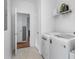 Bright laundry room with newer washer and dryer, shelving, and painted doors at 747 Dill Sw Ave, Atlanta, GA 30310