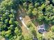 Aerial view showcasing the property's expansive lot and a detached structure surrounded by trees at 128 Golden Hills Dr, Woodstock, GA 30189