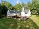 A large backyard with a well-maintained lawn and a deck overlooking the landscape at 128 Golden Hills Dr, Woodstock, GA 30189