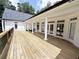 Large back porch with a wood floor and white columns overlooking the backyard at 128 Golden Hills Dr, Woodstock, GA 30189