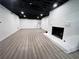 Unfinished basement with a painted fireplace, dark ceiling and light gray walls at 128 Golden Hills Dr, Woodstock, GA 30189