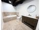 Modern bathroom featuring a soaking tub, toilet, and vanity with stone tile floors at 128 Golden Hills Dr, Woodstock, GA 30189