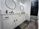 Bathroom with double sink vanity, white cabinets, and tub/shower with dark gray subway tile at 128 Golden Hills Dr, Woodstock, GA 30189