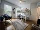 Cozy bedroom featuring a bunk bed, area rug, and natural light at 128 Golden Hills Dr, Woodstock, GA 30189