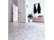 Elegant entryway with a unique geometric tile floor, decorative bench, and doors that create a welcoming and stylish entrance at 128 Golden Hills Dr, Woodstock, GA 30189