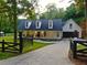 Beautiful home with a covered front porch and a well-maintained lawn and landscaping at 128 Golden Hills Dr, Woodstock, GA 30189