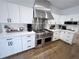 Gourmet kitchen with stainless steel appliances, white cabinets, and granite countertops at 128 Golden Hills Dr, Woodstock, GA 30189