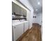Convenient laundry room with washer, dryer, and storage cabinets for optimal organization at 128 Golden Hills Dr, Woodstock, GA 30189