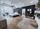 Modern main bedroom with hardwood floors, black accent wall, lots of windows, and ceiling fan at 128 Golden Hills Dr, Woodstock, GA 30189