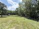 Expansive grassy yard enclosed by a wooden fence, with mature trees providing a serene backdrop at 128 Golden Hills Dr, Woodstock, GA 30189