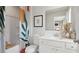 Bright bathroom featuring a tub with a shower, large mirror, modern vanity, and contemporary artwork at 1305 Lakota Pl, Atlanta, GA 30315