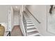 Entryway featuring wood and white stairs and runner, offering a clean, contemporary aesthetic with an abundance of natural light at 1305 Lakota Pl, Atlanta, GA 30315