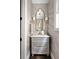 Half-bathroom with a grey cabinet and gold mirror frame at 2110 Timball Nw Rd, Atlanta, GA 30318