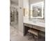 Stylish bathroom vanity with a lighted mirror, storage drawers, and a glass shower in the background at 2110 Timball Nw Rd, Atlanta, GA 30318