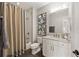 Well-lit bathroom with granite countertops, white cabinetry, and a shower with a curtain at 2110 Timball Nw Rd, Atlanta, GA 30318