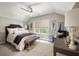 Cozy bedroom with a ceiling fan, large window, and comfortable furnishings at 2110 Timball Nw Rd, Atlanta, GA 30318