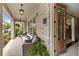 Inviting covered porch with brick flooring and a view of a home's interior through glass doors at 2110 Timball Nw Rd, Atlanta, GA 30318