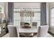 Well-appointed dining room with stylish chandelier, neutral colors, and ample natural light at 2110 Timball Nw Rd, Atlanta, GA 30318