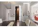 Contemporary dining room with modern chandelier, elevator access, and stairs to the upper level at 2110 Timball Nw Rd, Atlanta, GA 30318