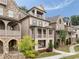 View of a neighborhood featuring brick homes with covered porches and well-maintained lawns at 2110 Timball Nw Rd, Atlanta, GA 30318