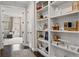 Bright hallway featuring built-in bookshelves and dark hardwood floors leading to the Primary bedroom at 2110 Timball Nw Rd, Atlanta, GA 30318