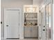 Hallway with a built-in shelving unit for decorative display, flanked by a door and french doors at 2110 Timball Nw Rd, Atlanta, GA 30318