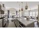 Modern, airy kitchen with island seating, stainless steel appliances, and pendant lights opens to dining and living spaces at 2110 Timball Nw Rd, Atlanta, GA 30318