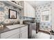 Well-lit laundry room with modern appliances and stylish patterned wallpaper at 2110 Timball Nw Rd, Atlanta, GA 30318