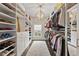 Organized walk-in closet with custom shelving, drawers, and ample hanging space for clothes and shoes at 2110 Timball Nw Rd, Atlanta, GA 30318