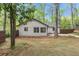 Spacious backyard with new sod and mature trees surrounds this home with a privacy fence at 3915 Ivy Ne Rd, Atlanta, GA 30342