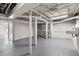 Unfinished basement space with exposed utilities, a sink, a large shelving unit, and door to the outside at 3915 Ivy Ne Rd, Atlanta, GA 30342