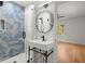 Bathroom featuring a blue geometric tile shower and modern sink with black hardware at 3915 Ivy Ne Rd, Atlanta, GA 30342