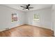 Hardwood bedroom with two windows and a ceiling fan at 3915 Ivy Ne Rd, Atlanta, GA 30342