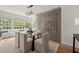 Elegant dining room with glass table, modern light fixture, and unique wine storage at 3915 Ivy Ne Rd, Atlanta, GA 30342