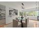Bright dining room with large windows and a modern glass-top table and seating at 3915 Ivy Ne Rd, Atlanta, GA 30342