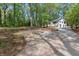 Traditional home with a long driveway, mature landscaping, and lush green lawn at 3915 Ivy Ne Rd, Atlanta, GA 30342