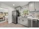 Kitchen with stainless steel fridge, gray cabinets, and marble backsplash at 3915 Ivy Ne Rd, Atlanta, GA 30342