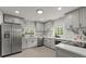 Modern kitchen with gray cabinets, stainless steel appliances, and marble backsplash at 3915 Ivy Ne Rd, Atlanta, GA 30342