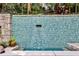 A serene backyard water feature of blue tile overspilling into a pool with a lounge area for relaxation at 1933 Mclendon Ne Ave # A, Atlanta, GA 30307