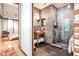 Modern bathroom featuring a glass shower enclosure and industrial-style sink with an open view of the bedroom at 1933 Mclendon Ne Ave # A, Atlanta, GA 30307