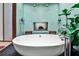Bright bathroom with soaking tub, dual shower heads, and green tile accents at 1933 Mclendon Ne Ave # A, Atlanta, GA 30307