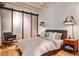 Cozy bedroom with a sliding closet door, exposed ceiling, stylish hanging lights and a comfortable bed at 1933 Mclendon Ne Ave # A, Atlanta, GA 30307