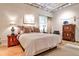 Bright bedroom featuring neutral tones, hardwood floors, an exposed ceiling, and unique artistic touches at 1933 Mclendon Ne Ave # A, Atlanta, GA 30307