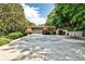 Front facade of home with trees, lush landscaping, and circular driveway made of interesting stone at 1933 Mclendon Ne Ave # A, Atlanta, GA 30307