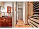 Hallway with hardwood floors, closet with organized shoe racks, and dresser with vanity items at 1933 Mclendon Ne Ave # A, Atlanta, GA 30307