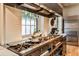 The kitchen includes an extensive range, stainless hood, and bright window at 1933 Mclendon Ne Ave # A, Atlanta, GA 30307
