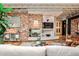 Contemporary living area featuring a brick accent wall, hardwood floors, and an open concept design at 1933 Mclendon Ne Ave # A, Atlanta, GA 30307