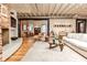 Cozy living area with brick accents, hardwood floors, modern furnishings, and an open floor plan at 1933 Mclendon Ne Ave # A, Atlanta, GA 30307