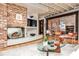 Bright living room with brick fireplace, hardwood floors, and an open layout perfect for entertaining guests at 1933 Mclendon Ne Ave # A, Atlanta, GA 30307